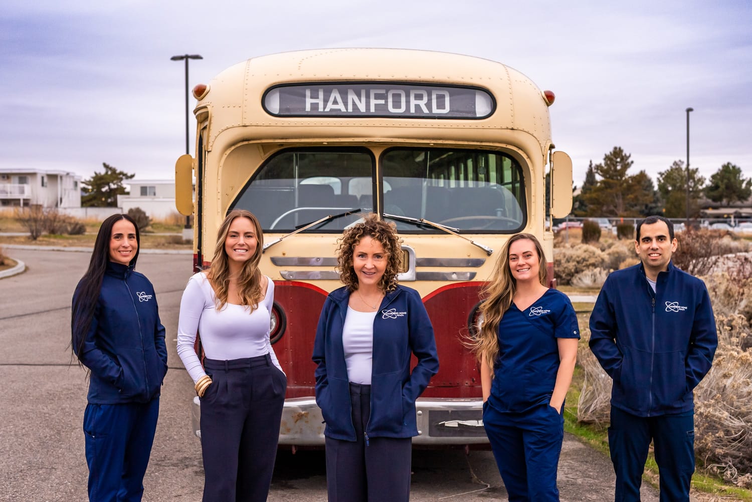 Hanford Home Health_Website Shoot_02.2025-00842 Hanford Home Health team in front of the Hanford bus